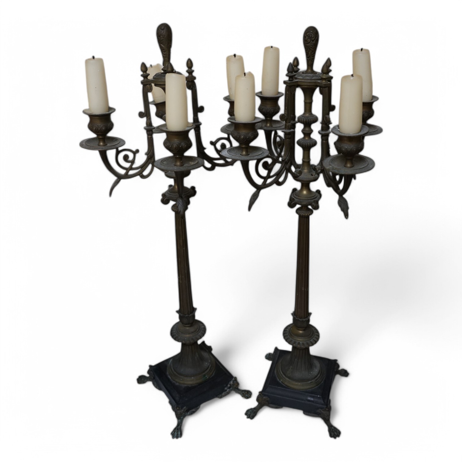 A pair of four branch candelabra raised on slate bases with paw feet, 62cm high. Condition - fair/good